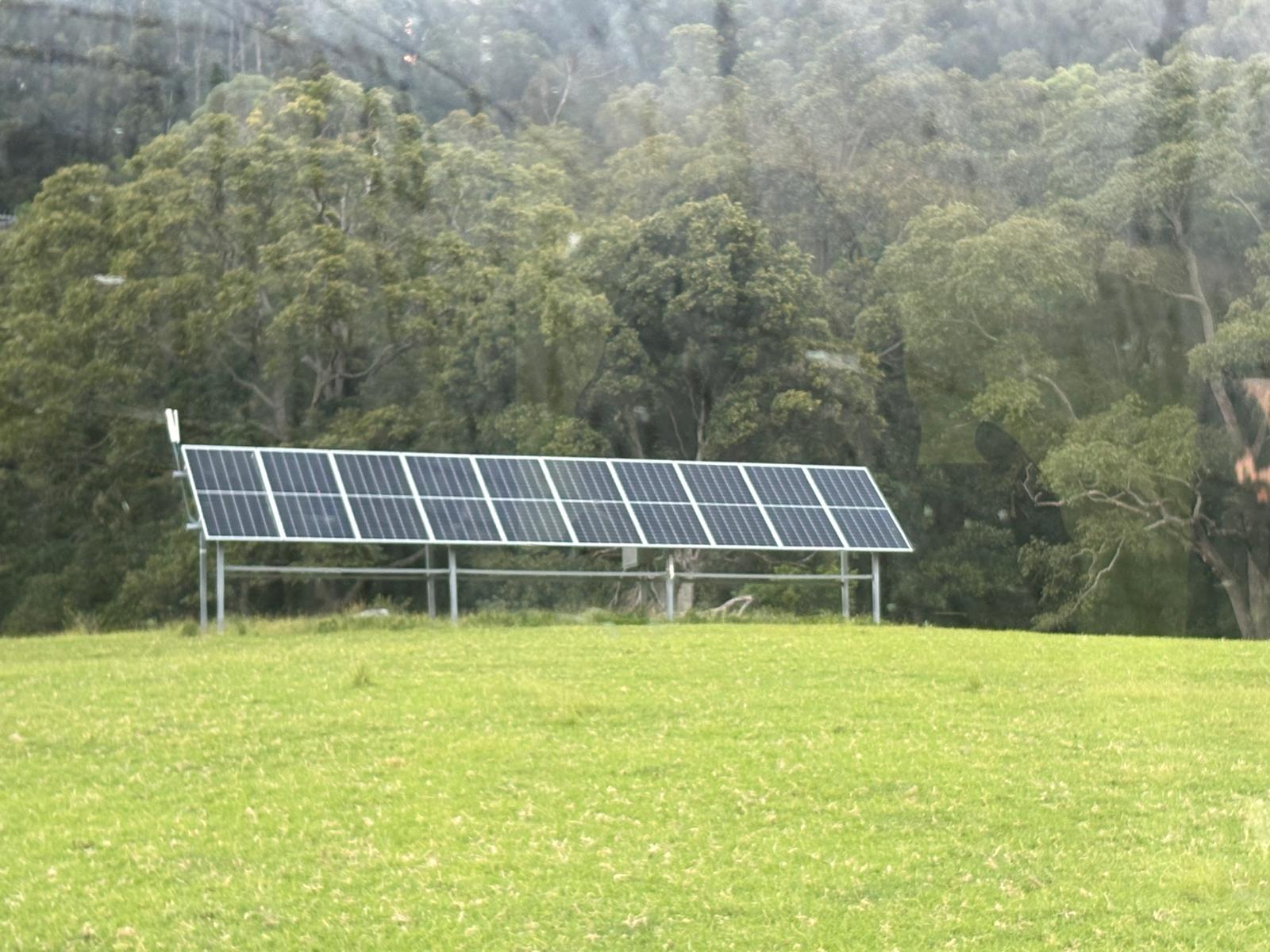 Ground-mounted solar array on a green paddock near Nowra